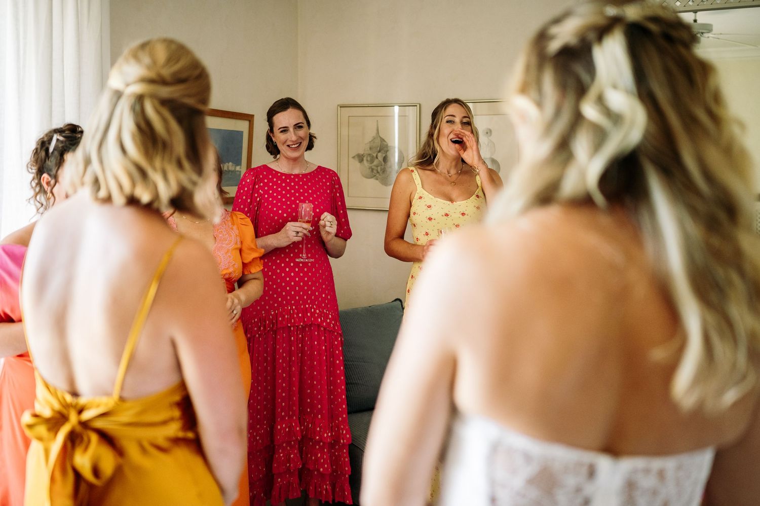 Colorful dresses in shades of red, yellow and orange during wedding preparations.