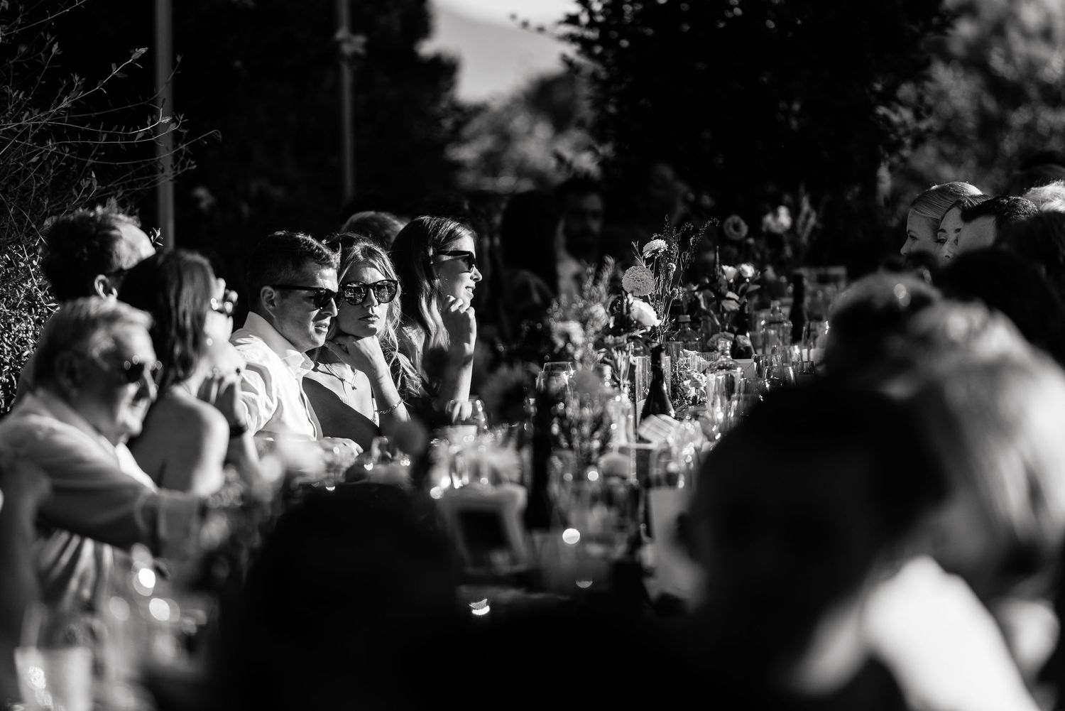 Black and white candid shots of wedding reception guests during evening celebrations.