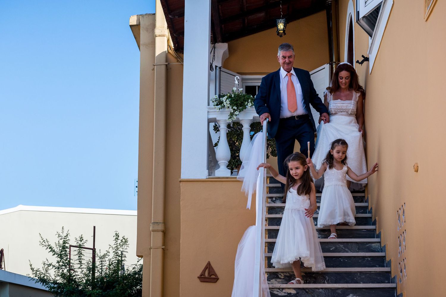 People descending outdoor stairs at a wedding venue.