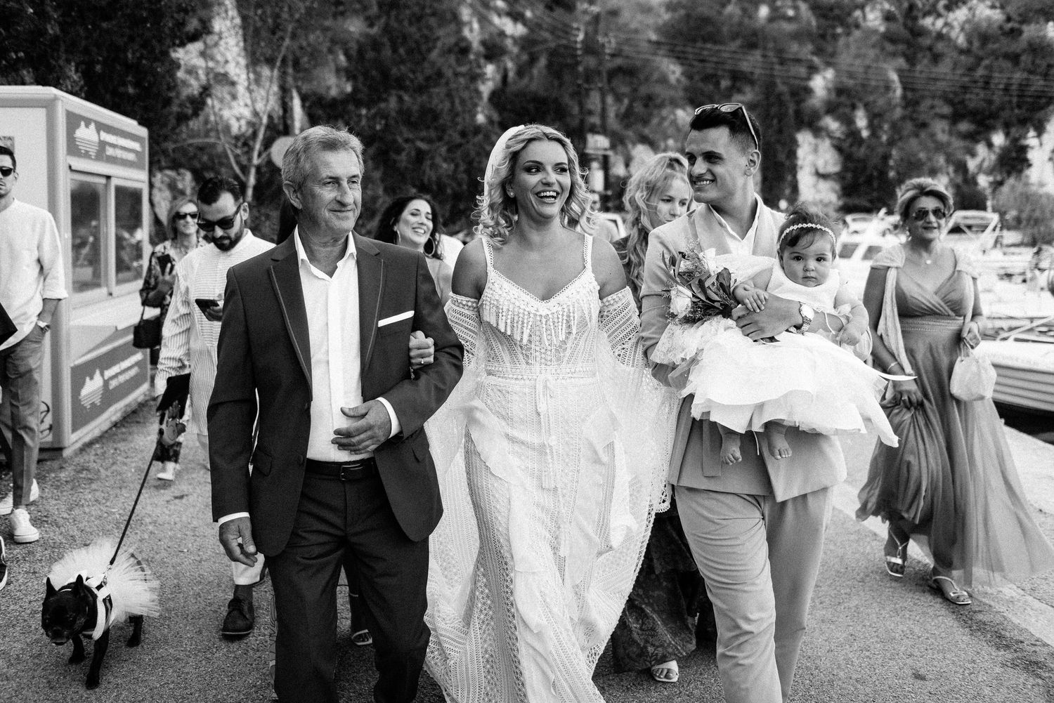 Wedding party walking and celebrating together outdoors.