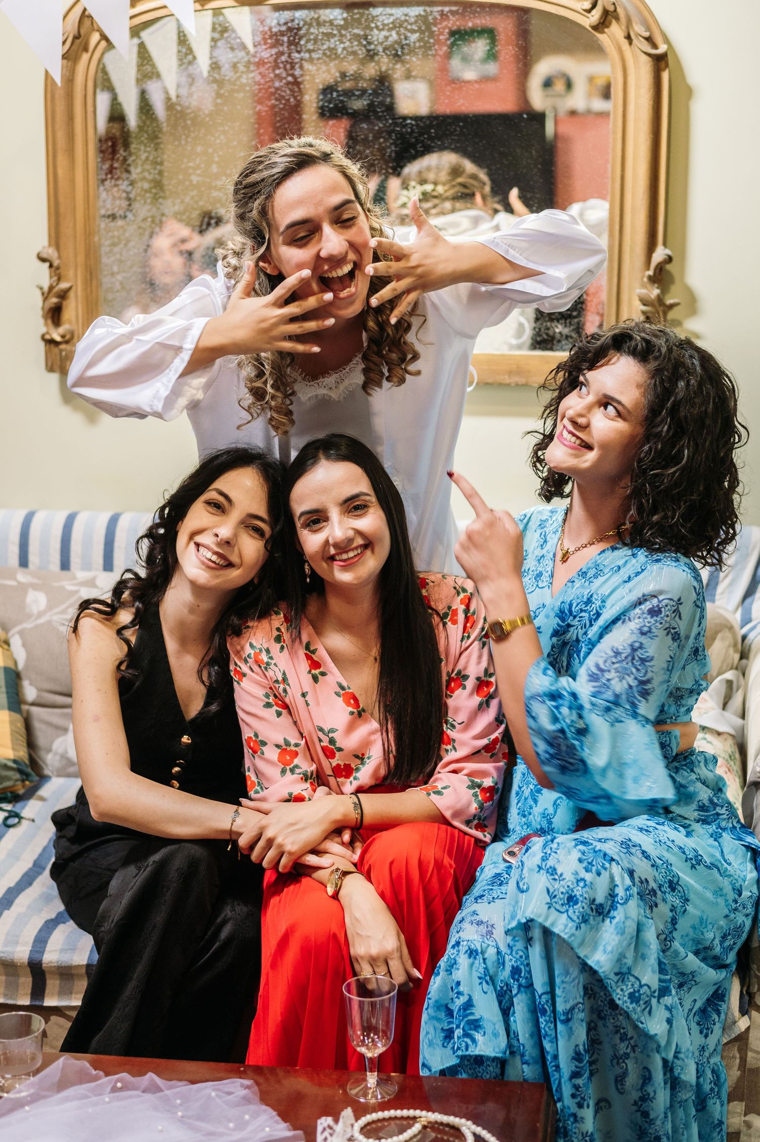 Wedding party enjoying candid moments and laughter during celebration.