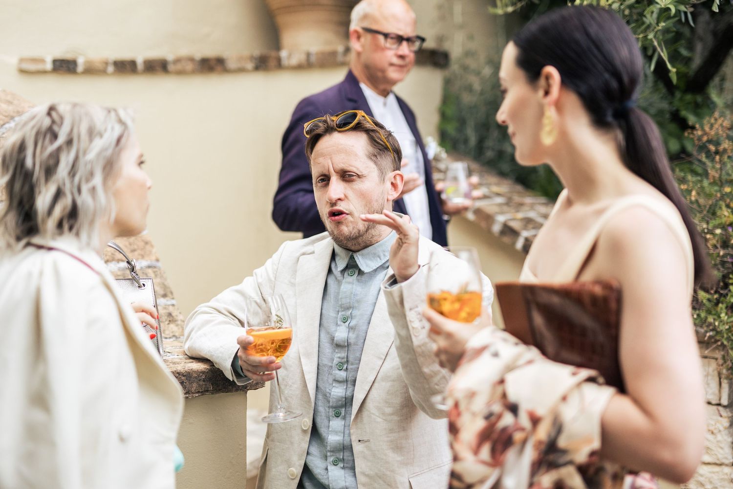 Wedding guests enjoying cocktails and conversation at an outdoor reception.