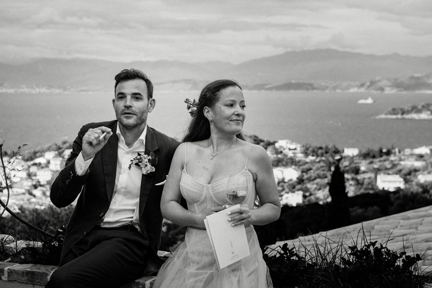 Black and white panoramic photo series showing a couple enjoying romantic moments on a hilltop overlooking a city.