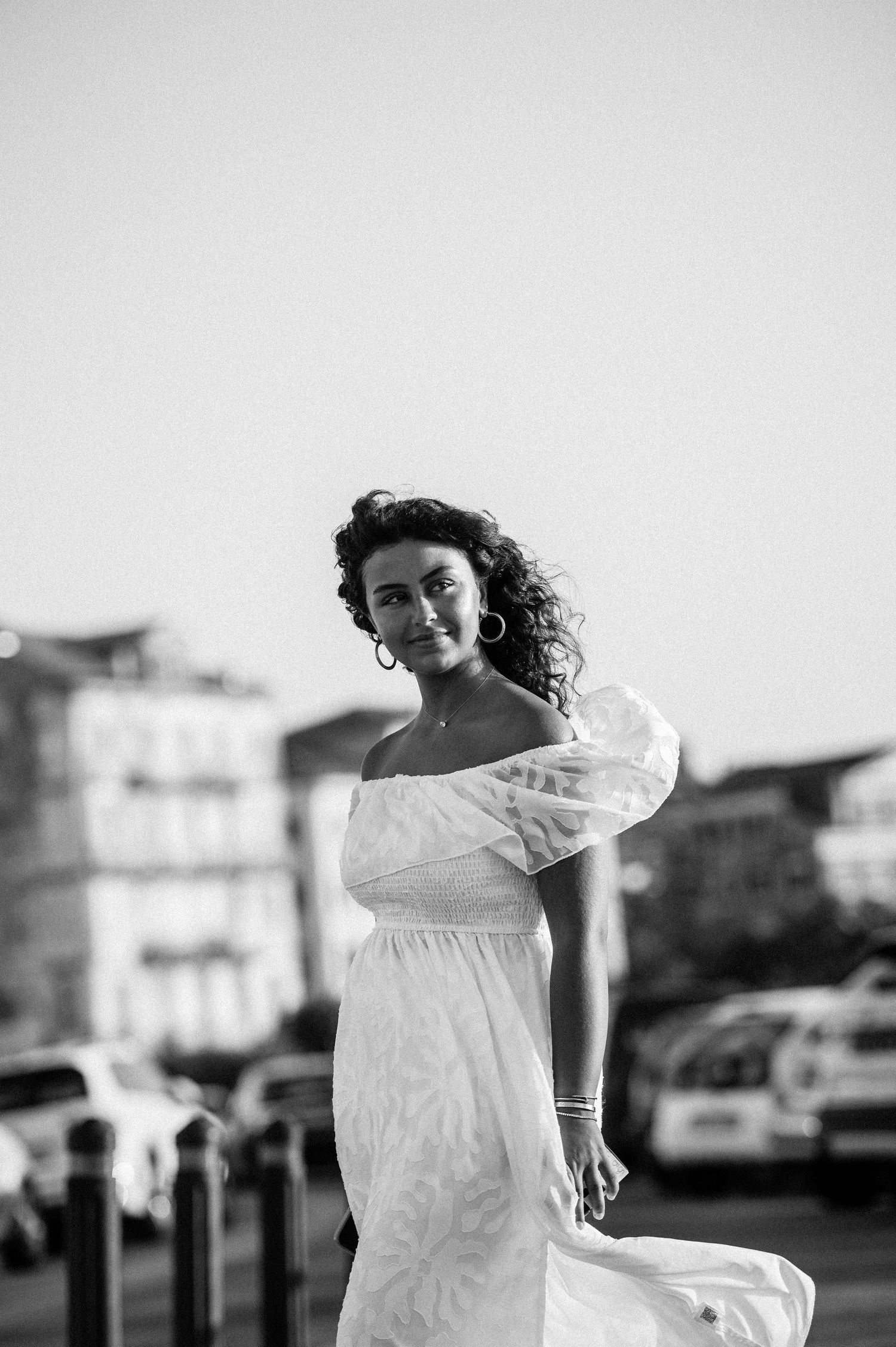 Black and white portrait series against architectural backdrop in dramatic lighting.