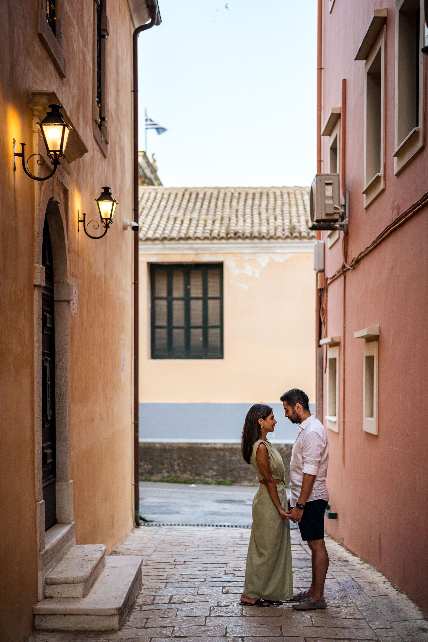 A romantic scene in a quaint alley with salmon-colored walls and traditional architecture.