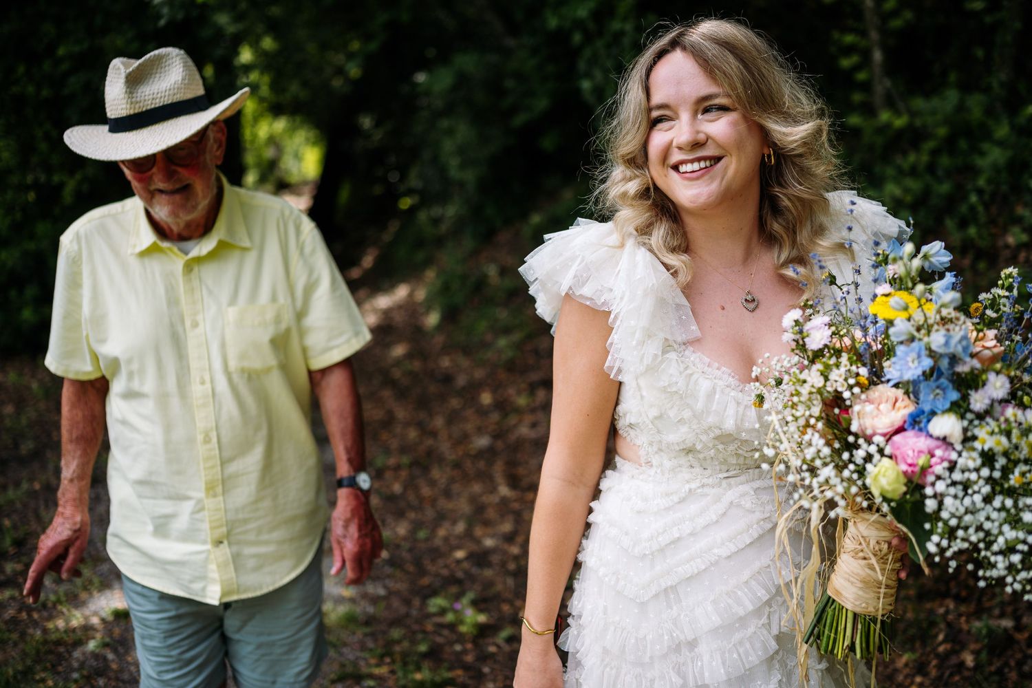 Candid outdoor celebration moments captured in natural lighting among trees.