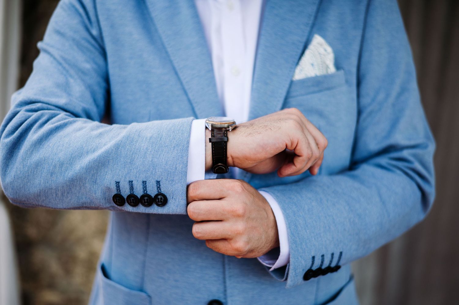 Detail shots of light blue suit jacket with white pocket square.