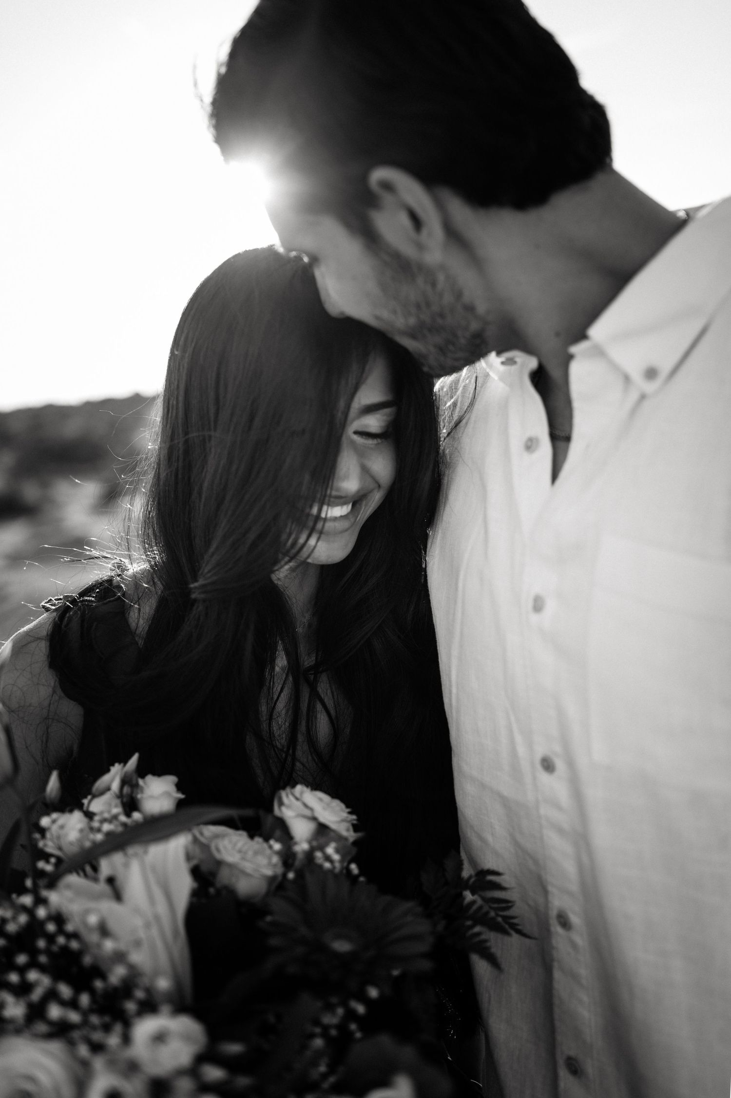 Black and white intimate portraits of a couple sharing tender moments together.