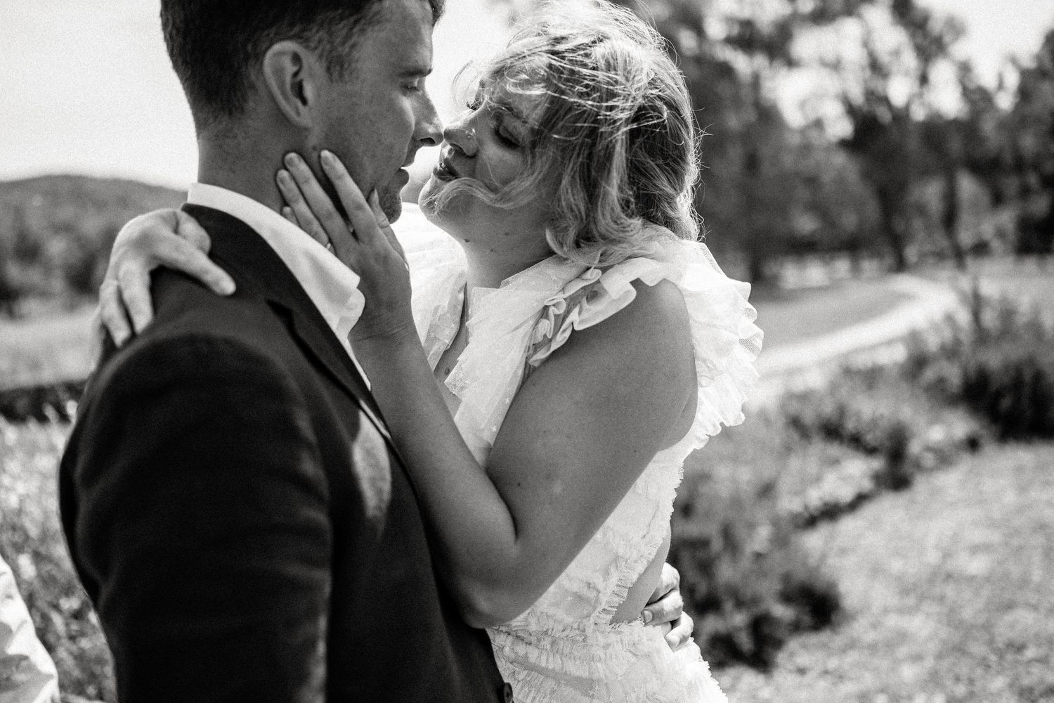 Series of intimate black and white wedding portraits in a natural outdoor setting.