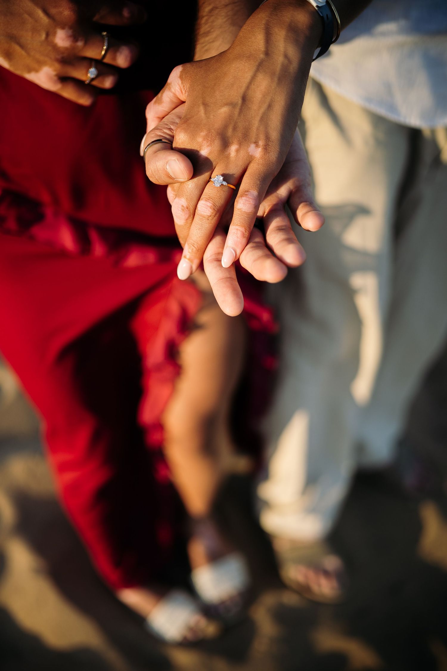Close-up shot of hands holding each other against a blurred background.