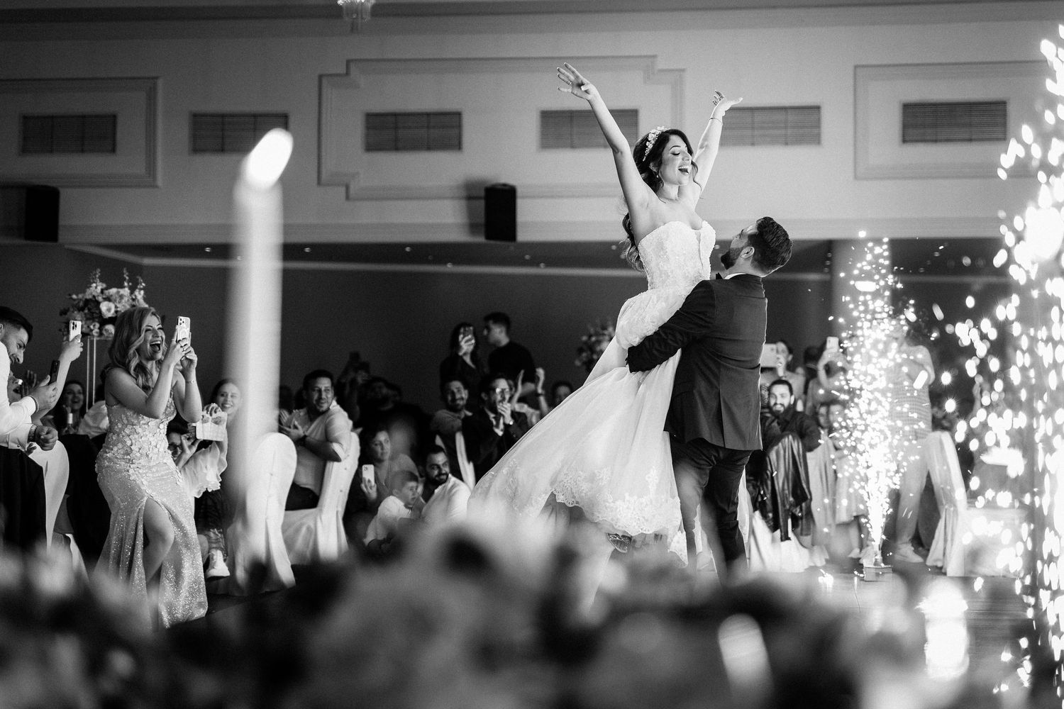 Wedding reception dance floor filled with joyful celebration and sparklers creating a magical atmosphere.