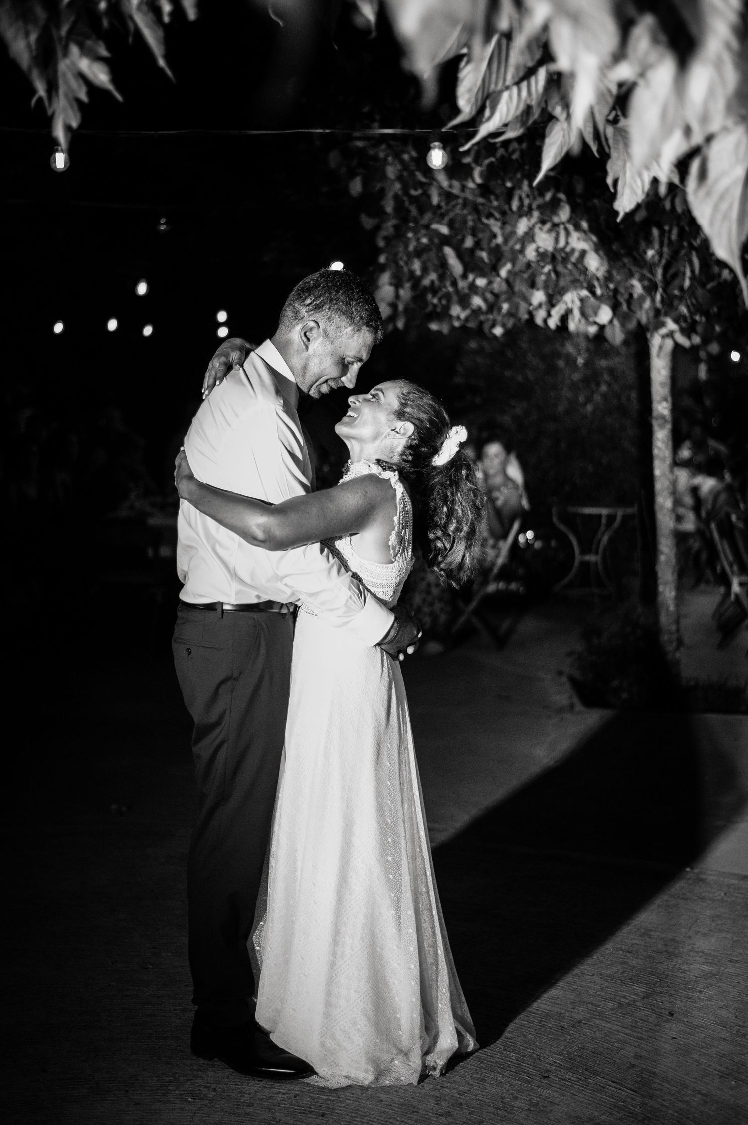 Black and white photos capture romantic dance moments at an outdoor evening wedding reception.