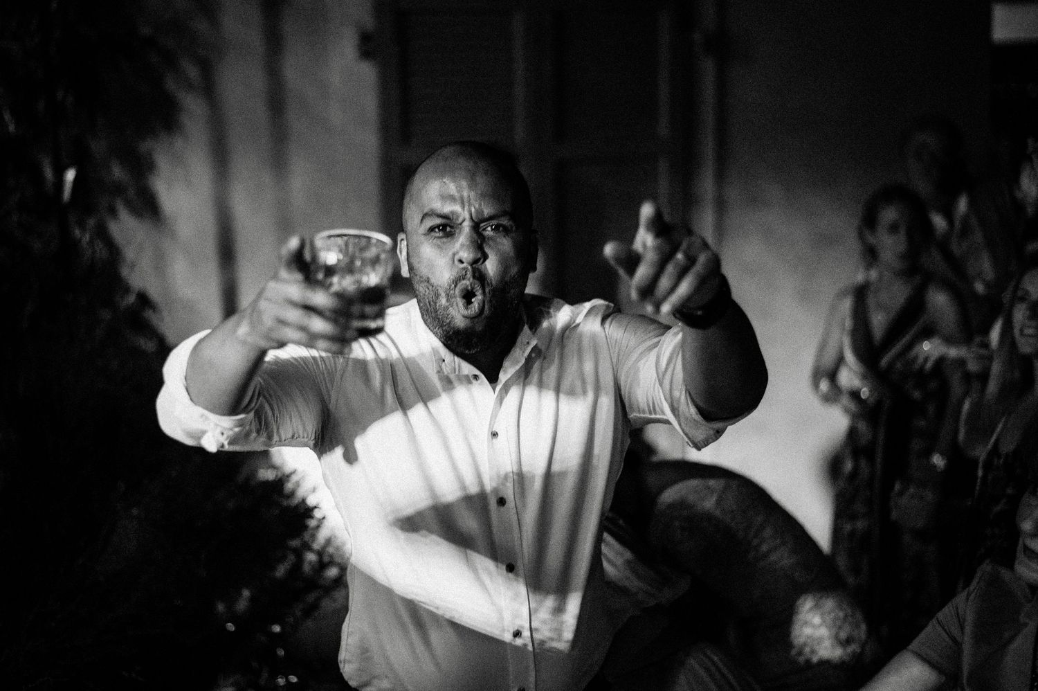 Black and white photos of energetic party scenes with dramatic lighting.