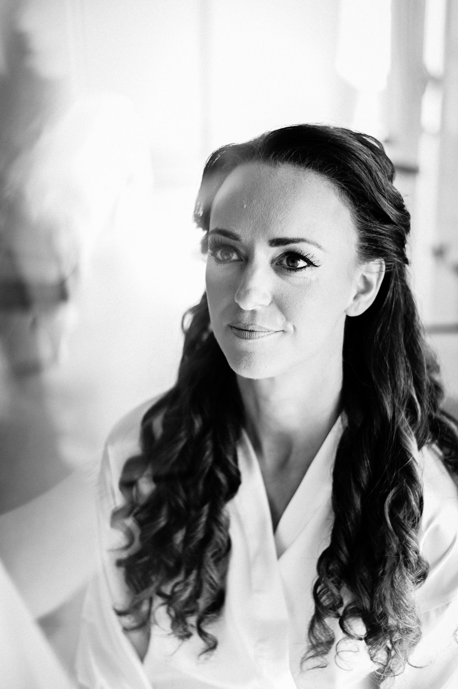 Black and white portraits showing bride's elegant hairstyle and makeup.