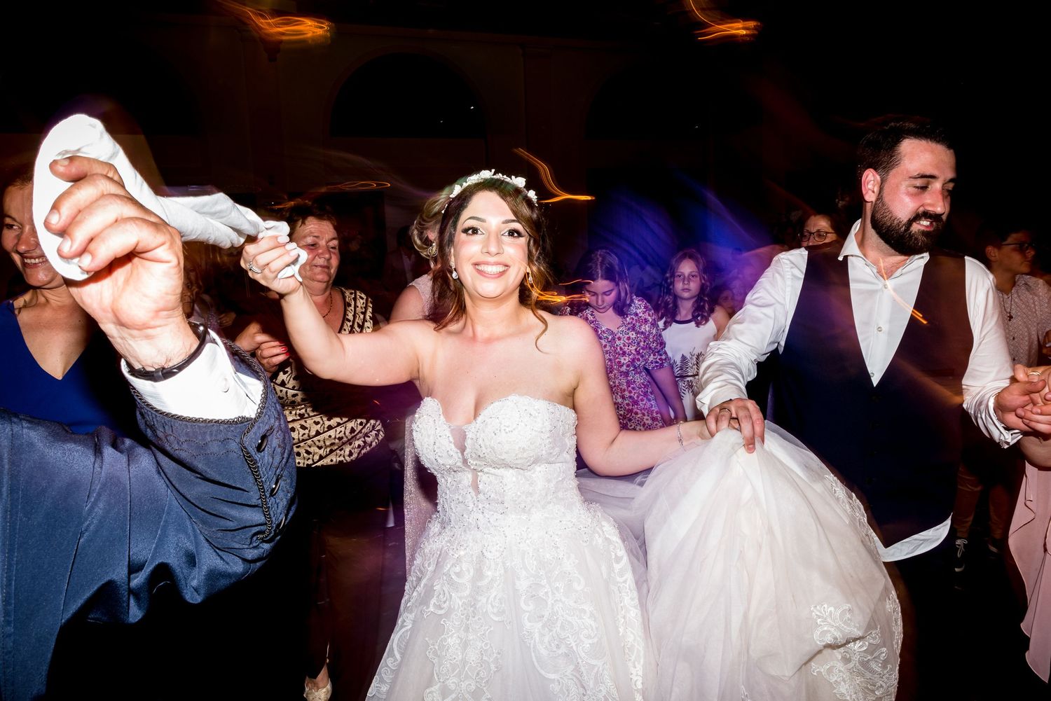 Wedding reception dance floor packed with guests enjoying an energetic celebration.