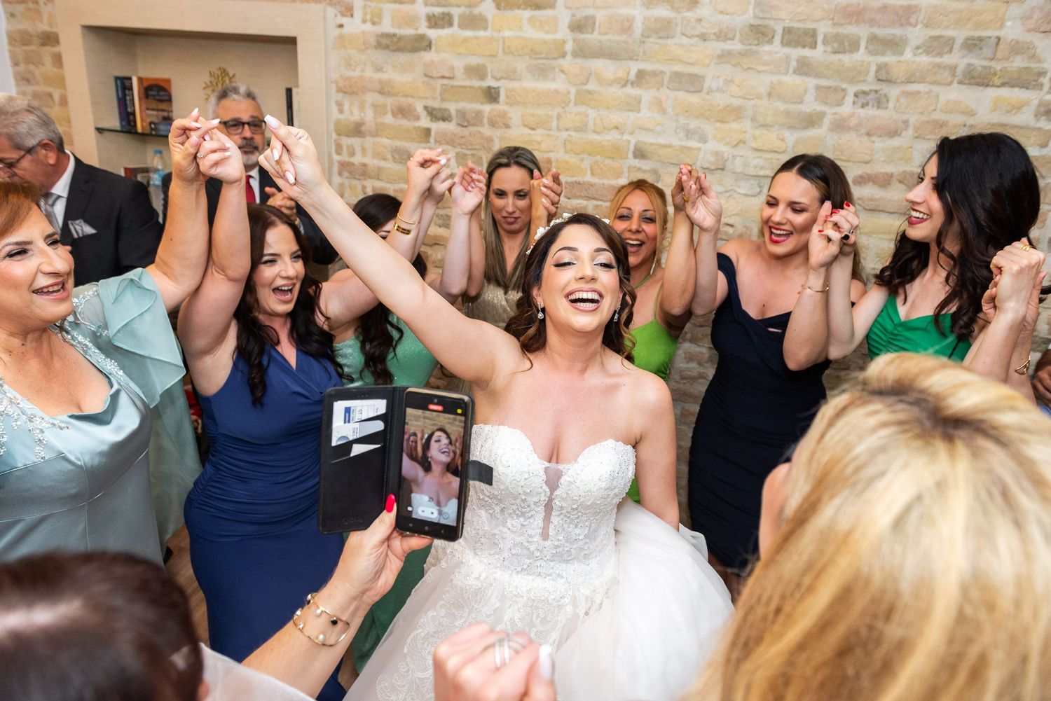 Wedding guests celebrate and dance during a lively reception.