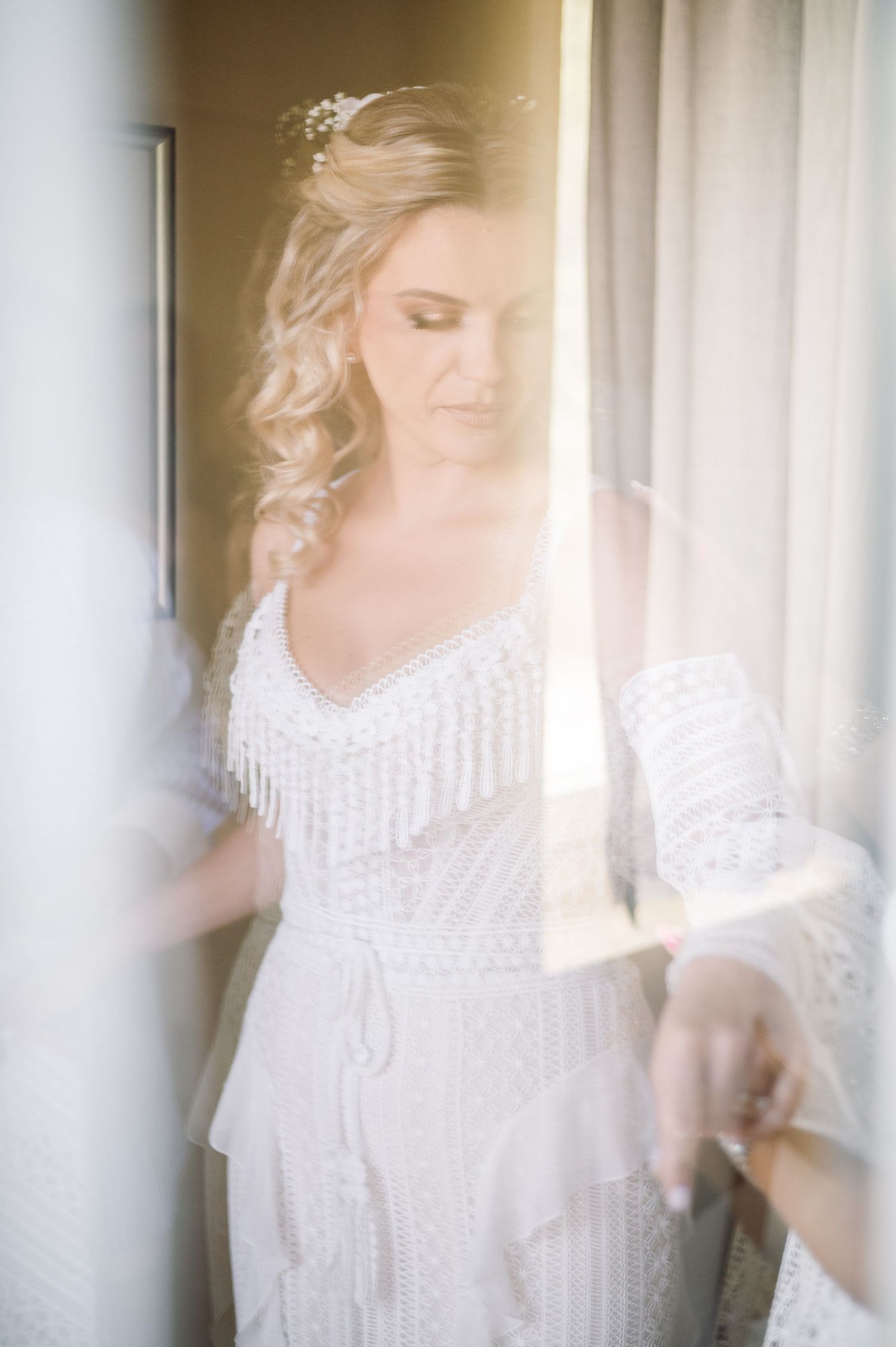 Ethereal series of shots showing a white lace dress in natural window light.