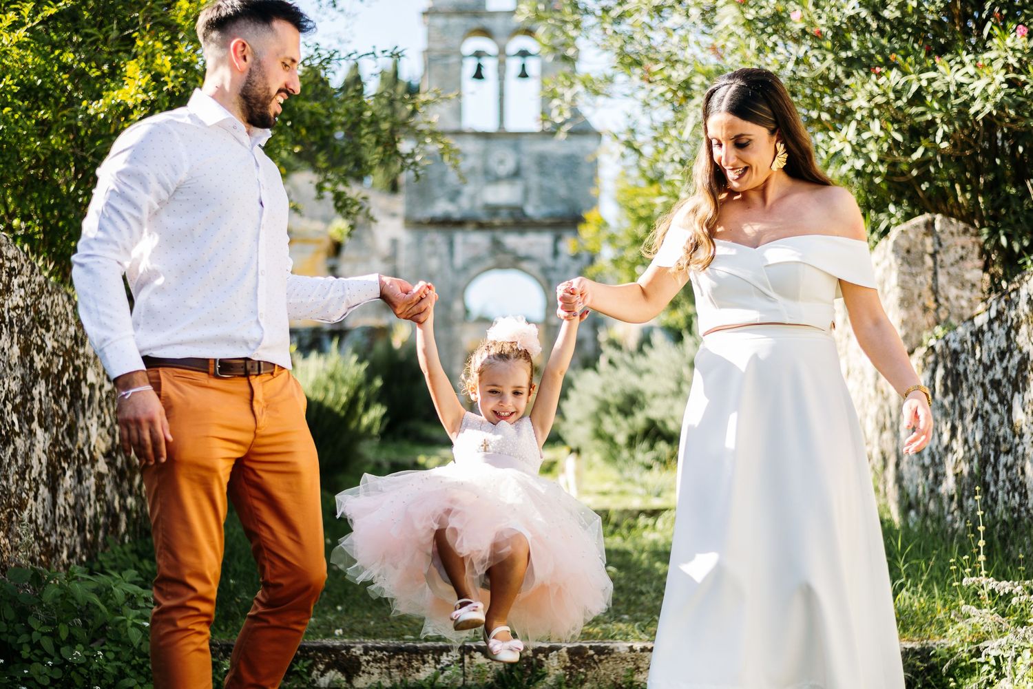 Celebratory moment in garden setting with tulle dress and formal attire.