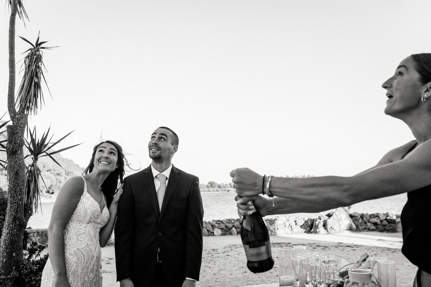 A romantic couple shares a joyful moment together during their beach wedding photoshoot.