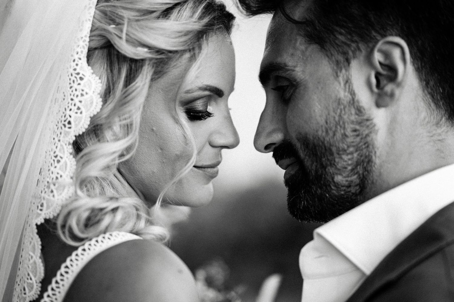 Black and white portrait of tender wedding moment.