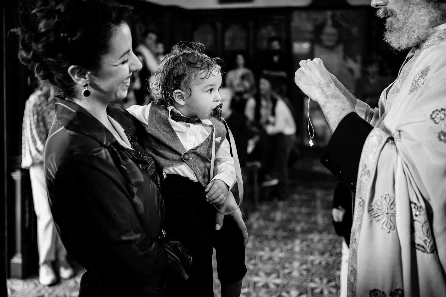 A black and white image of a religious ceremony with participants in traditional dress.