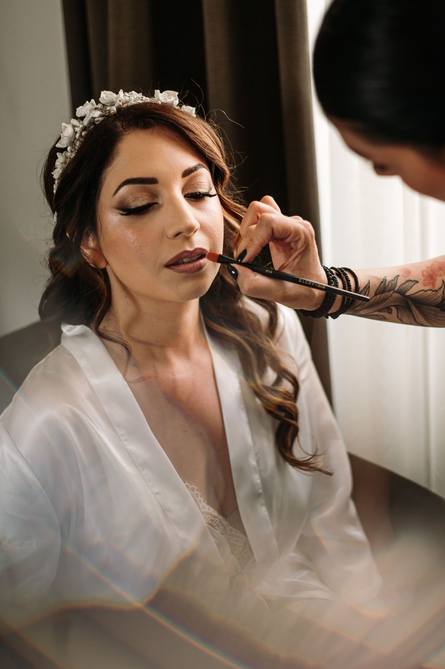 Close-up shots of bridal makeup application in a softly lit room.