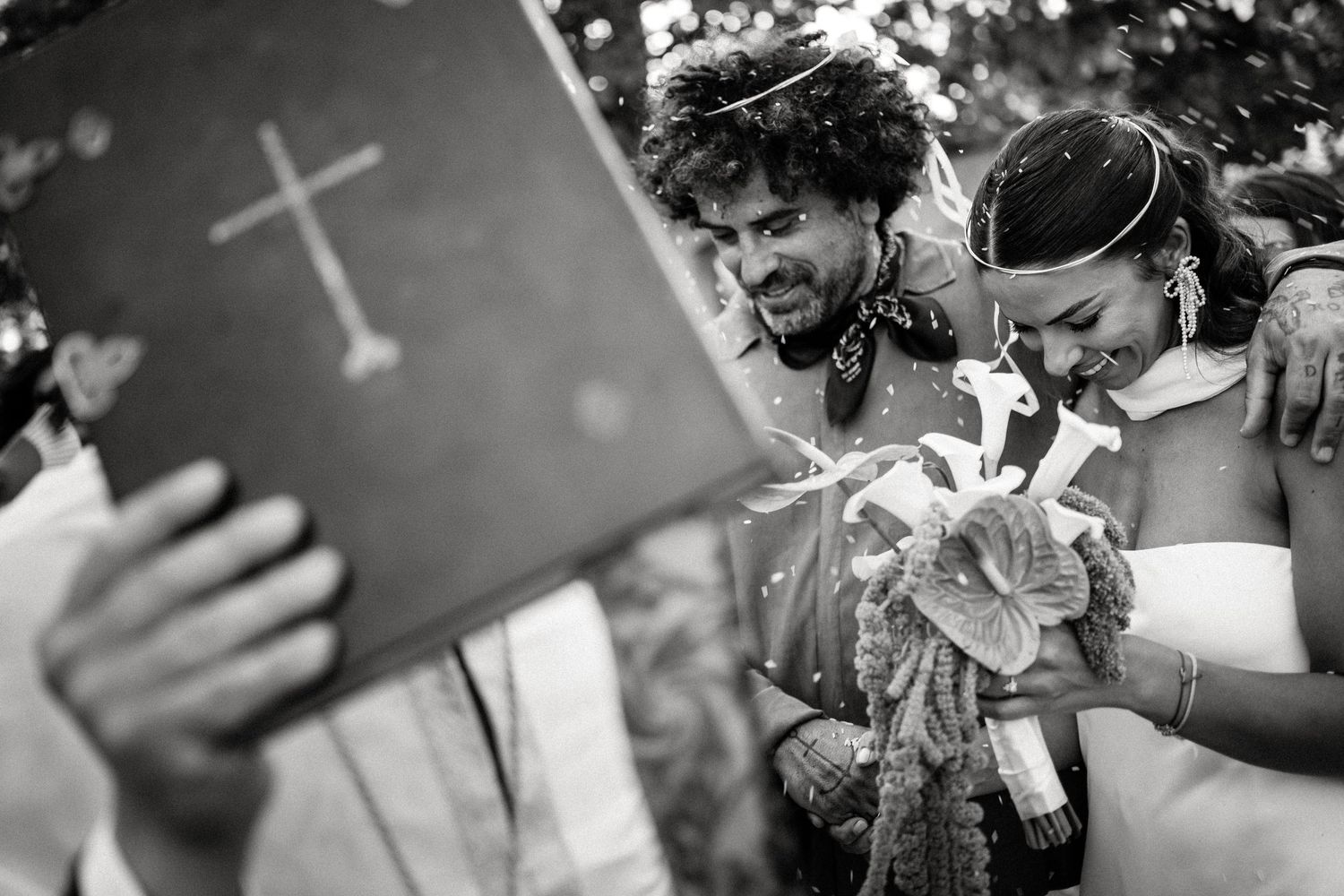 Black and white photo shows emotional moments during wedding ceremony readings.