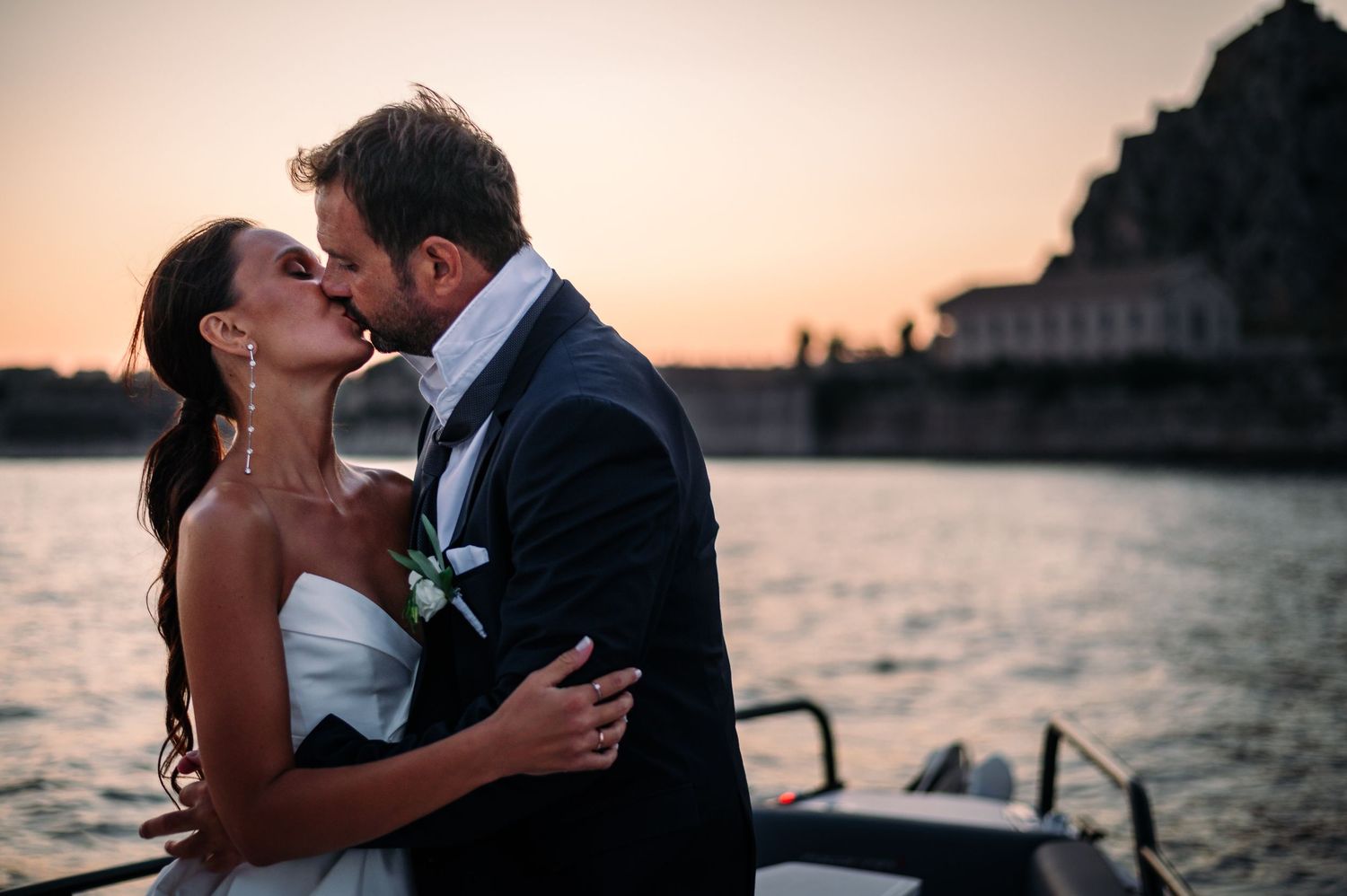 Romantic sunset wedding portraits captured against Mediterranean coastal backdrop.