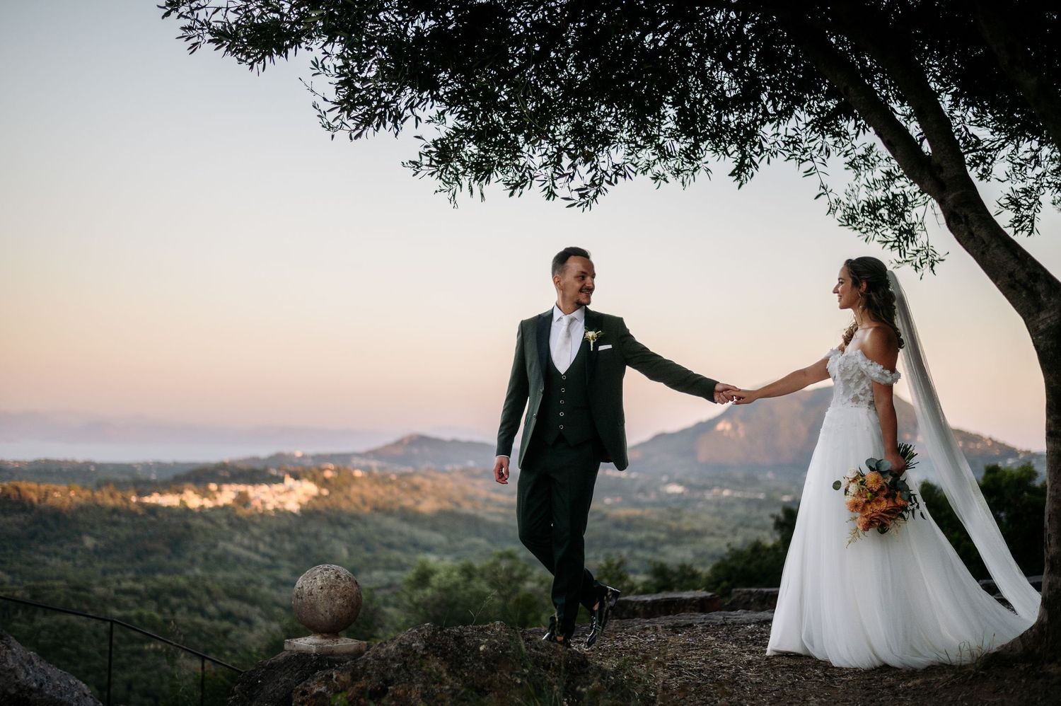 Scenic mountain landscape wedding photos with couple silhouetted against sunset sky.
