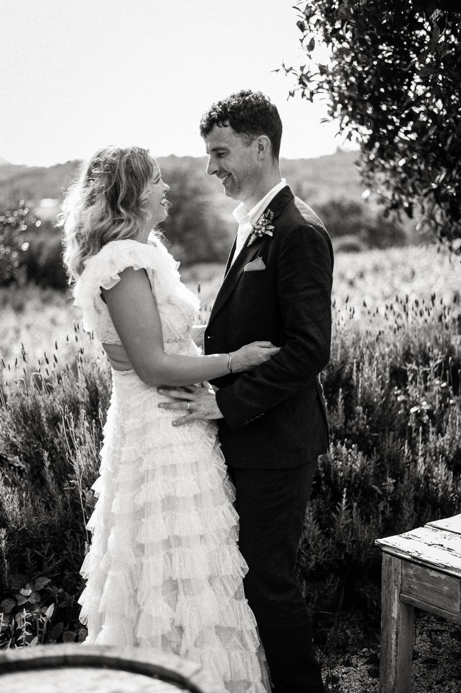Black and white photos of couple dancing in a garden setting.