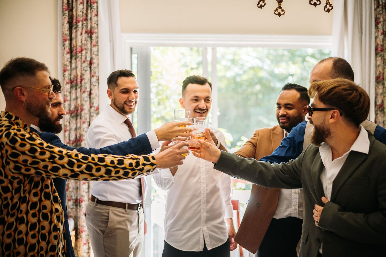 Group of people in formal attire dancing and celebrating at an indoor event.