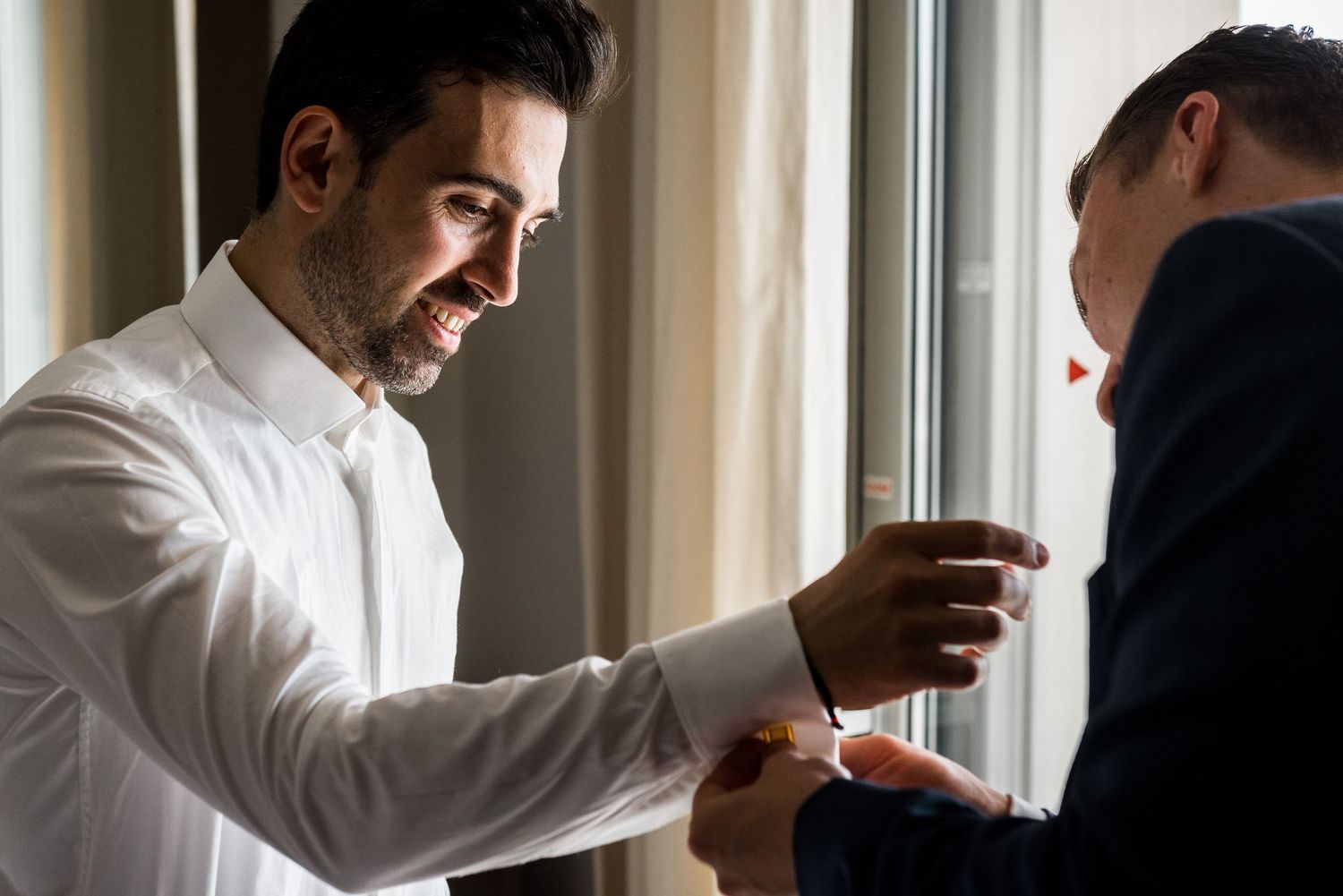 Candid moments of groom and groomsmen preparing for wedding ceremony indoors.