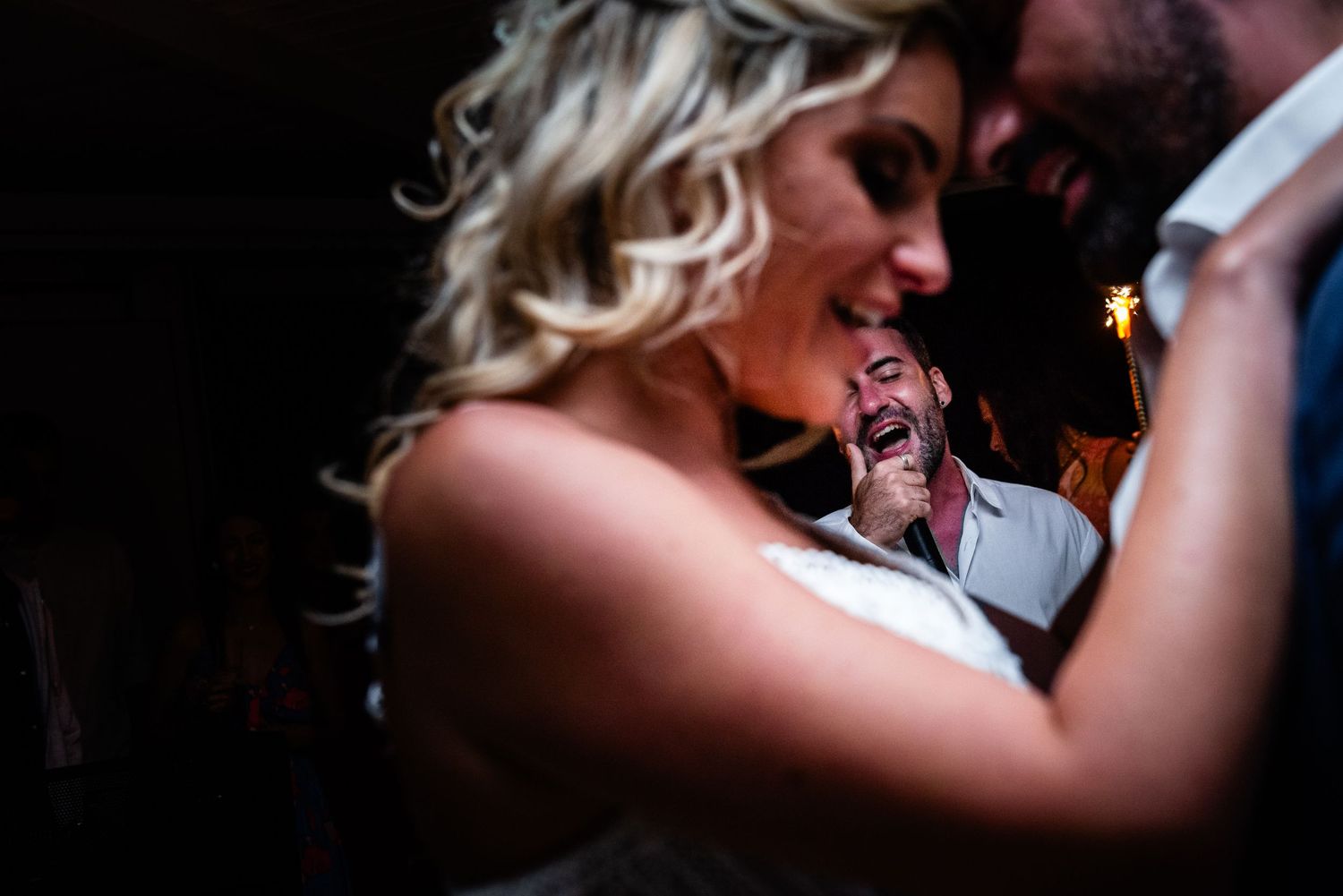 Intimate dance floor moments captured in dramatic low-light photography.