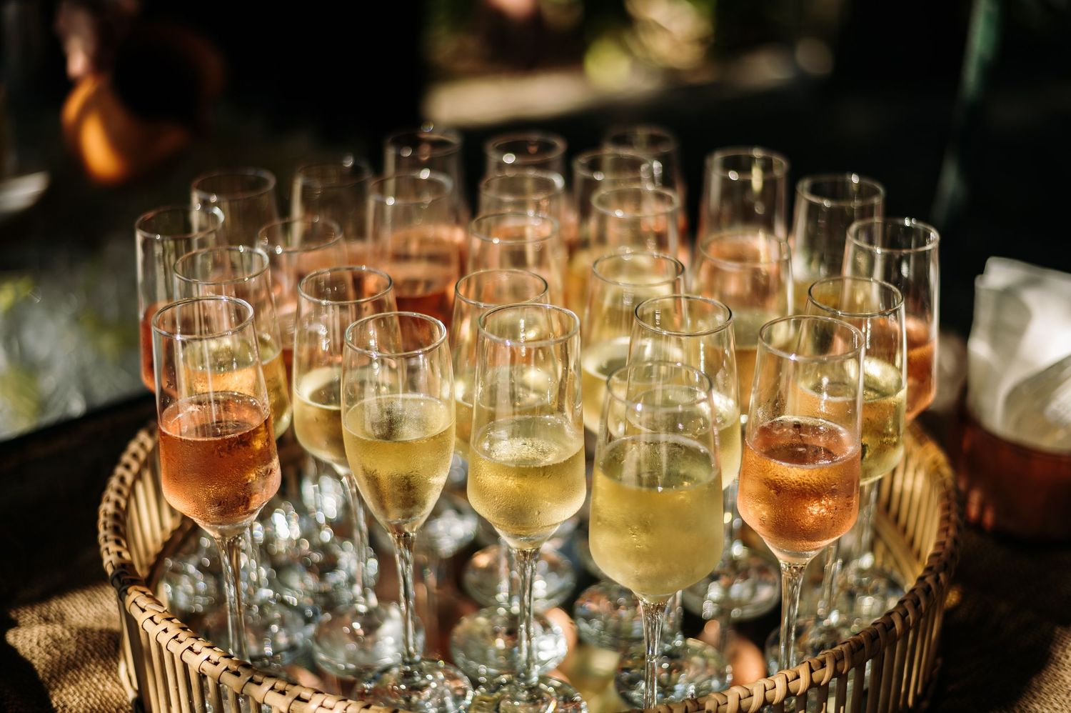 Elegant champagne and wine glasses arranged on a silver tray at an upscale event.