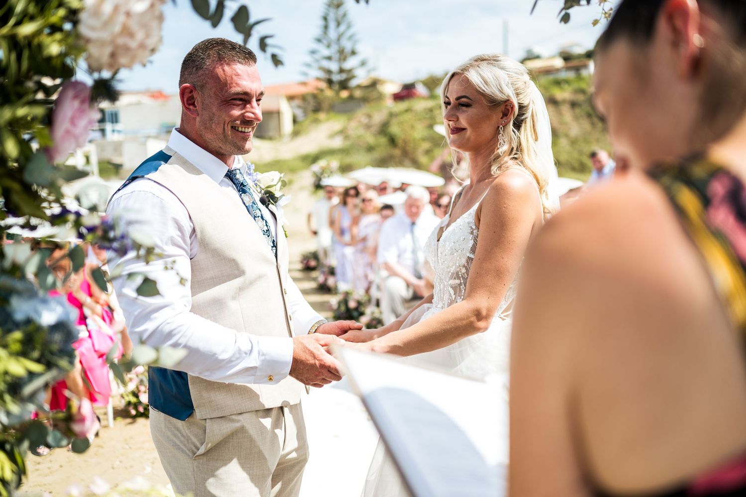 Candid moments from beach wedding ceremony with guests and couple.