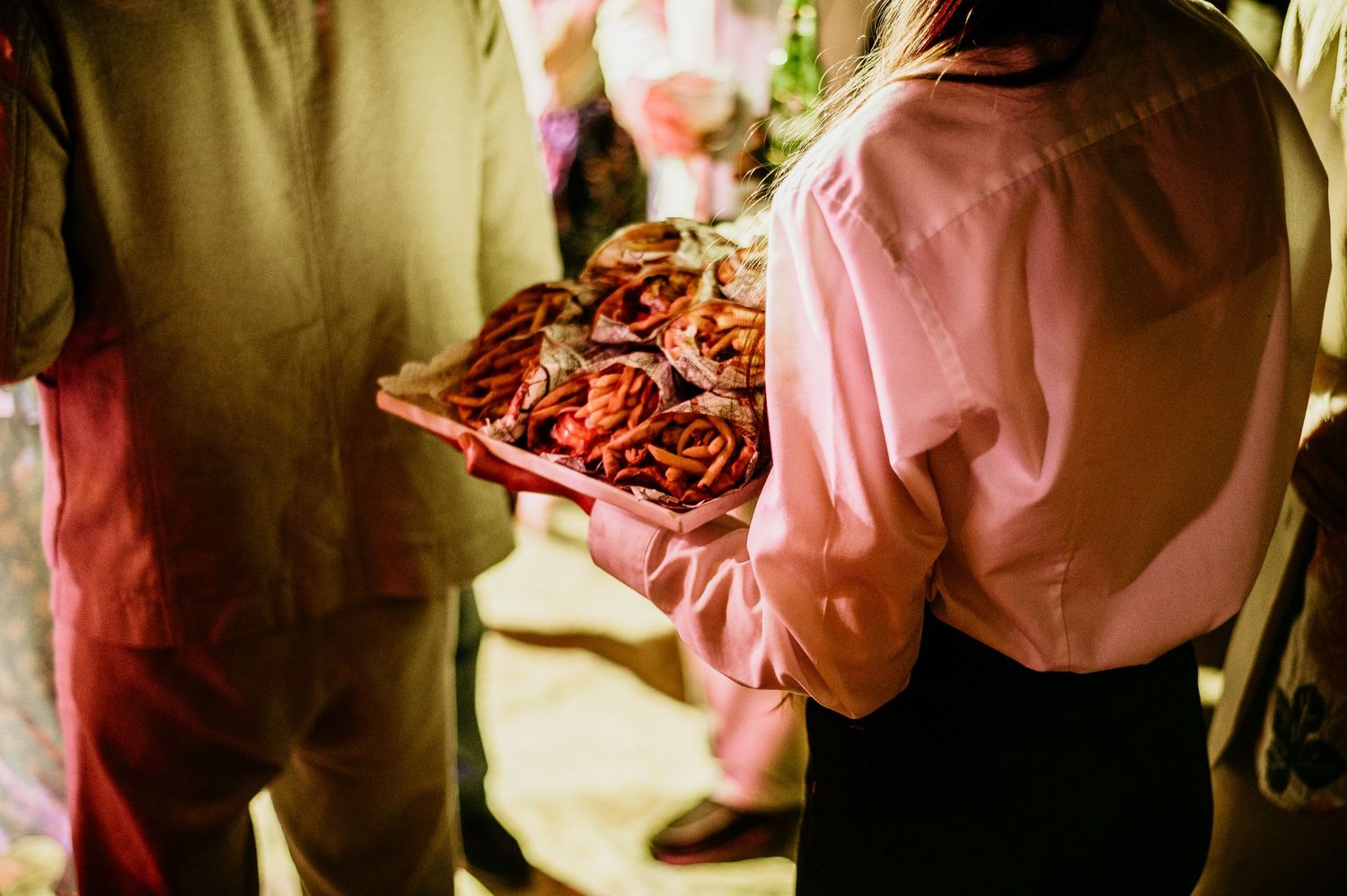 Party guests celebrating in close-up shots with warm lighting.