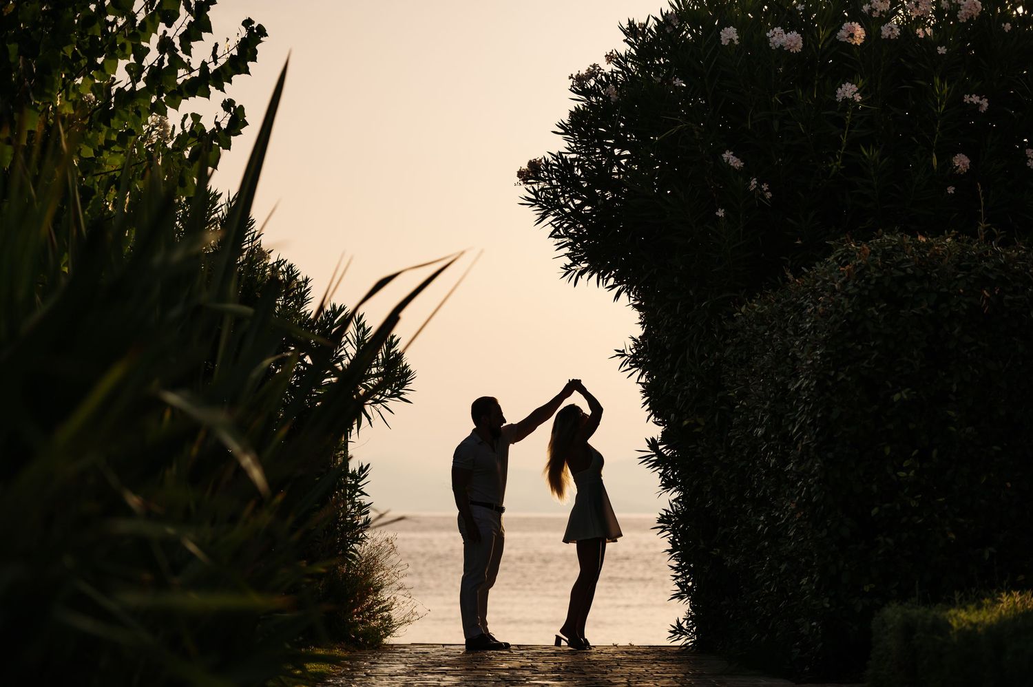 Silhouettes of a couple against a sunset sky creating romantic shadows.