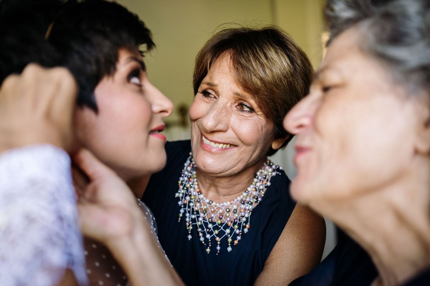 Joyful moments shared during wedding preparations with sparkling jewelry details.