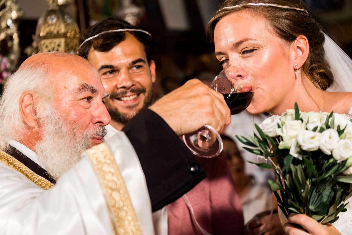 Wedding celebration with guests sharing drinks and laughter during reception.