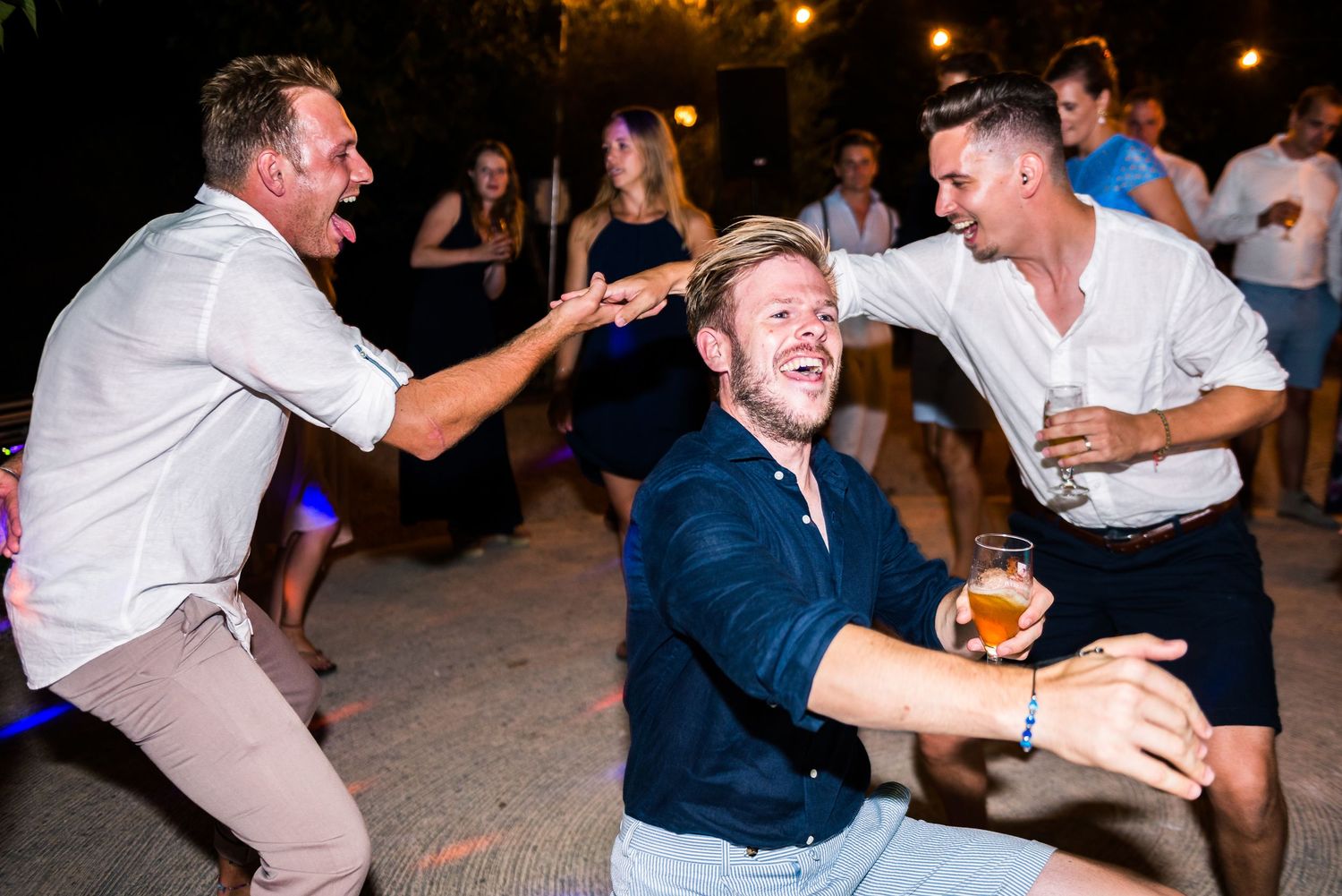 Candid shots of guests laughing and dancing at outdoor wedding celebration.