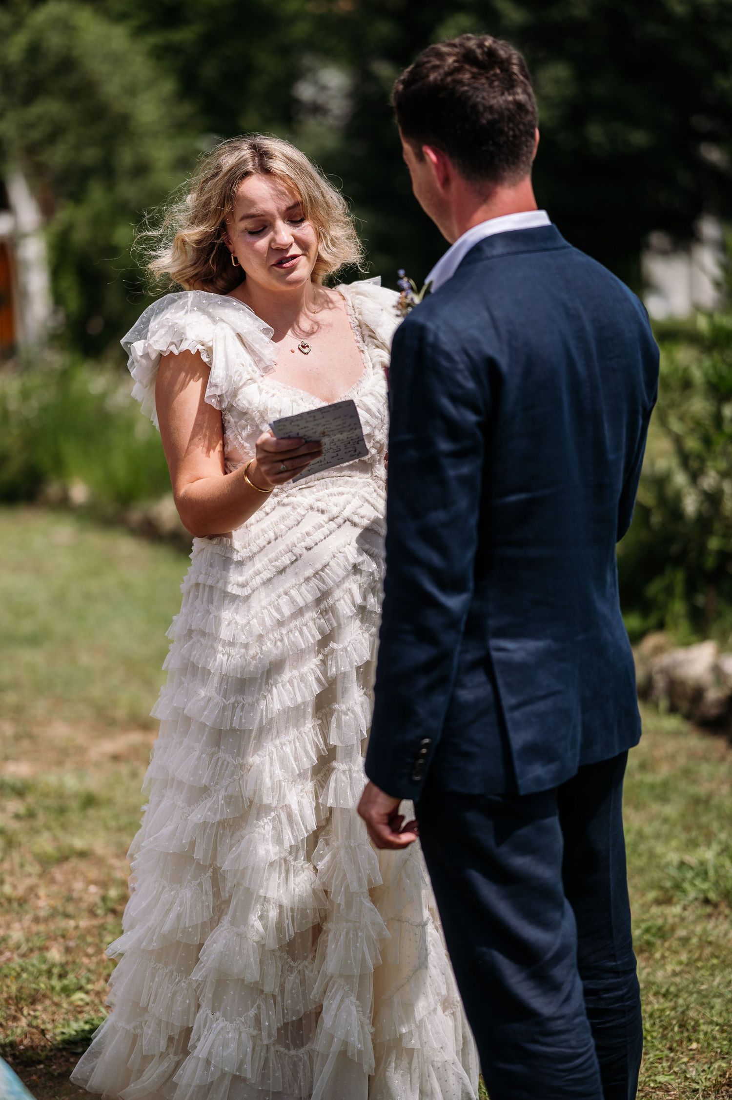 Elegant outdoor wedding scene with flowing white dress movement captured in natural light.