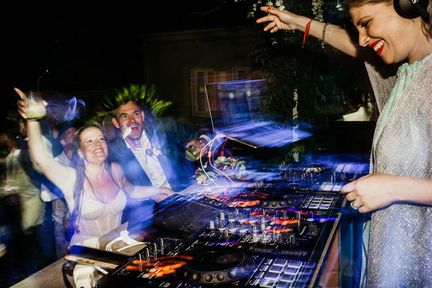 DJ mixing music at a nightclub with dramatic blue lighting and effects.