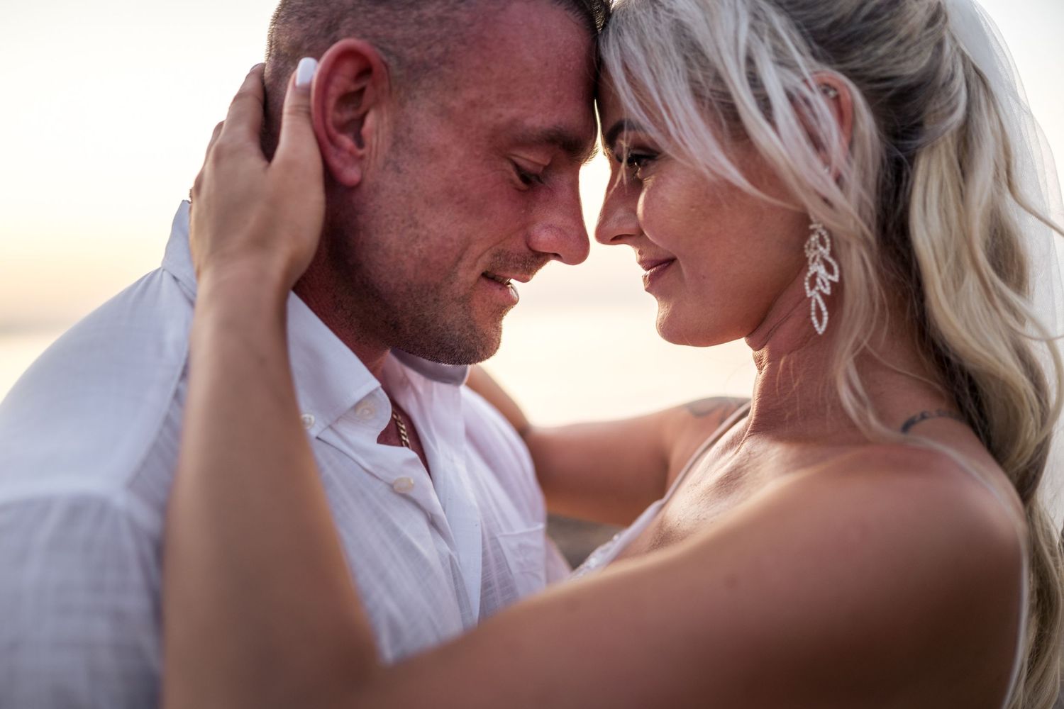 Romantic sunset portraits capturing intimate moments at the beach.
