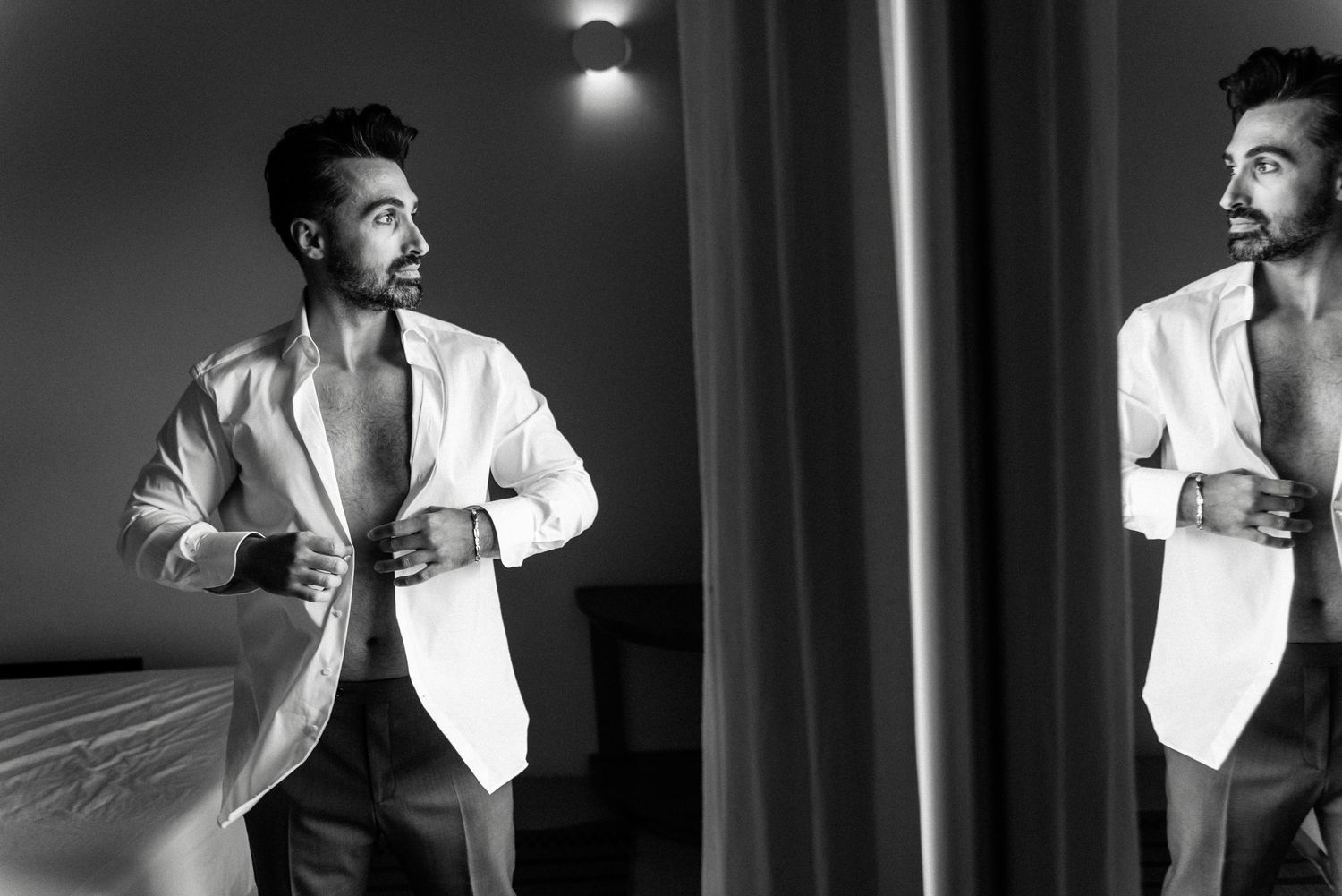 Sequence of expressive poses in white jacket against dark background.