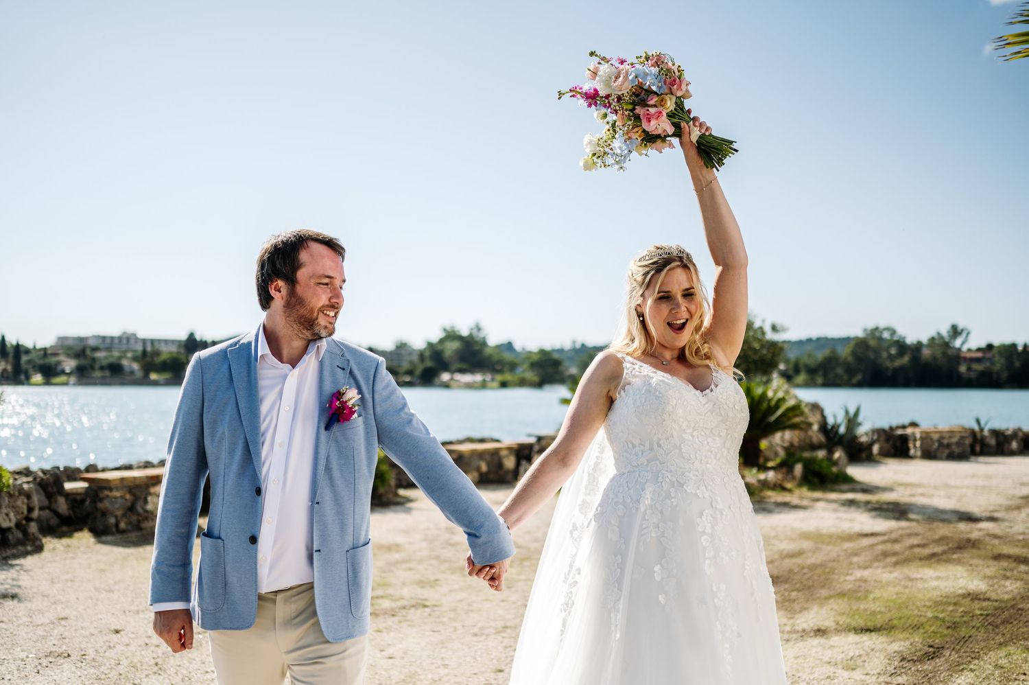 Romantic seaside wedding portraits with light blue and white attire.