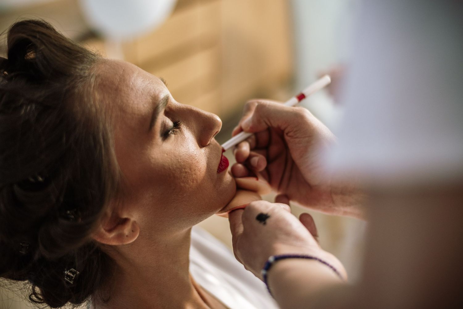 Professional makeup application sequence showing cosmetic details.