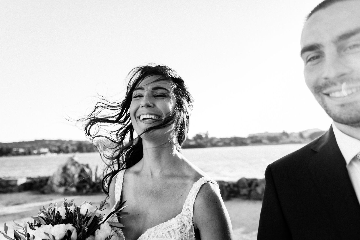 Candid black and white wedding portraits capture intimate moments between newlyweds.