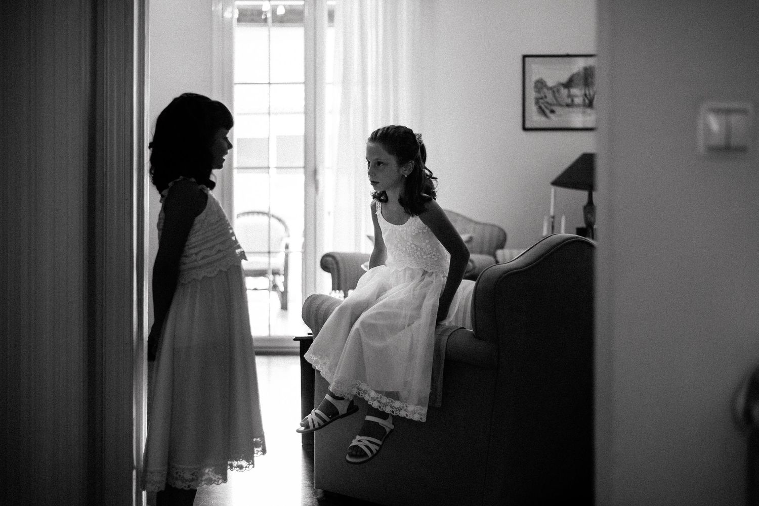 A silhouette of people in a sunlit room preparing for a special occasion.