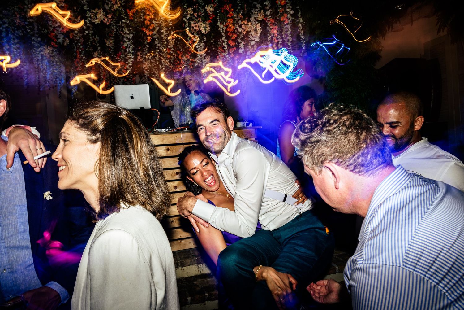Nightclub scene with dancers silhouetted against blue and orange lighting effects.