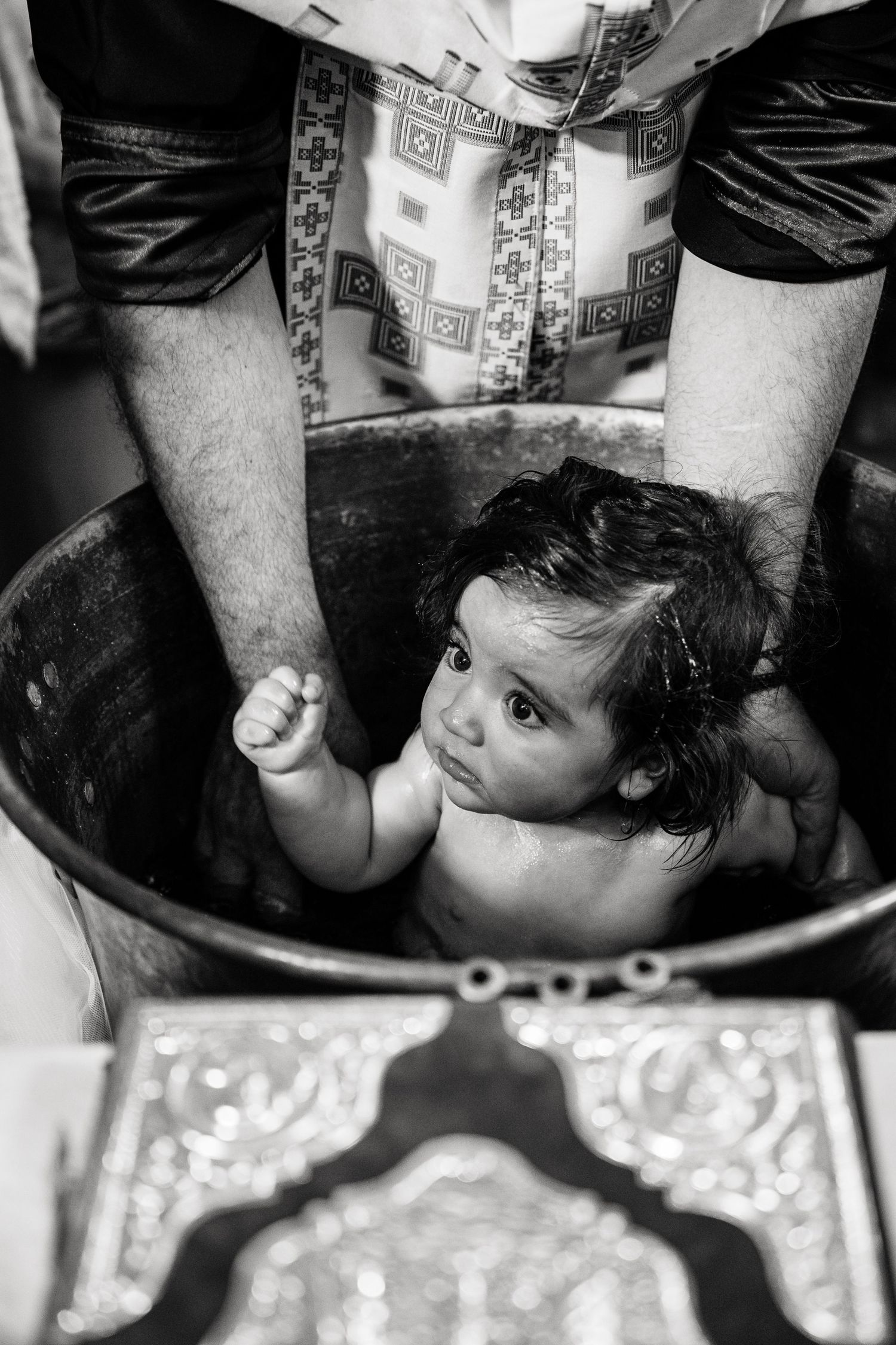Black and white image of bath time with decorative tiles visible.